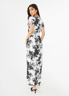 The Heidi Gown is inspired by retro caftan dresses reminiscent of 1960s glamour. This effortless style features a slashed v-neckline and a removable self-tie belt so you can accentuate the waistline, or wear the dress as a roomy gown. The romantic floral print is a vision of Summer elegance when paired with a heel and evening bag! Generous fit: We recommend sizing down if you are in between sizes. Make: Short Sleeve, V-Neckline, Back zipper closure, Fully lined, Removable self-tie belt Measureme Evening V-neck Belted Maxi Dress, Evening V-neck Maxi Dress With Tie Waist, V-neck Maxi Dress With Tie Waist For Evening, Belted V-neck Maxi Dress For Evening, White V-neck Maxi Dress With Tie Waist, Evening Belted Maxi Dress With Surplice Neckline, Evening V-neck Dress With Tie Waist, White Belted Maxi Dress, Chic Floor-length Tie Waist Dress