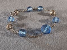 We are offering you this very stylish and truly stunning vintage silver tone blue crystal beads and fancy filigree beads chain bracelet. There are so many exciting design elements to this gorgeous piece! The bracelet features varying sizes of faceted blue crystal round beads alternating with silver tone chain links and fancy silver tone filigree round beads, it is magnificent! This is a must have item for the serious vintage jewelry collector! The impressive bracelet measures approx. 7 inches in Elegant Blue Crystal Bracelet With Silver Beads, Elegant Blue Metal Beaded Bracelets, Elegant Blue Beaded Metal Bracelets, Elegant Blue Crystal Bracelet With Polished Beads, Elegant Blue Beaded Nickel-free Bracelets, Elegant Blue Nickel-free Beaded Bracelets, Blue Crystal Beads, Beads Chain, Chain Links