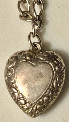 "This is a fabulous mini-collection of sterling silver hearts on a silver bracelet, ready to wear and add on if desired. You are buying FOUR puffy heart charm pendants for ONE price. They are ALL sterling silver and stamped. All of these hearts appear to be older, non-repros, dating to the early 1900s. They are on a 7\" silver (unmarked) charm bracelet and weigh a total of 8.7 grams. In very good vintage used condition, these are all sold as found, unpolished, lovely patina, all original and fre Valentine's Day Heart Charm Jewelry Collectible, Valentine's Day Collectible Jewelry With Heart Charm, Valentine's Day Collectible Heart Charm Jewelry, Heart-shaped Hallmarked Bracelets As A Gift, Silver Heart Bracelet With Sterling Clasp For Valentine's Day, Silver Charm Bracelet With Heart Beads, Sterling Silver Heart-shaped Engraved Charm Bracelet, Engraved Heart-shaped Sterling Silver Charm Bracelet, Anniversary Heart Pendant Charm Bracelet