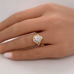 a woman's hand with a diamond ring on it