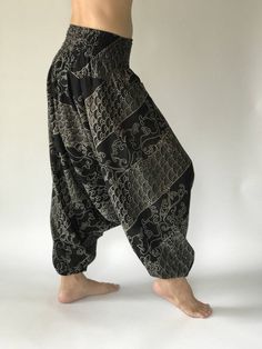 "These super soft rayon baggy unisex harem pants have the \"flow\", perfect of yoga or just a cool strolling. Comfort and character are what these pants are all about. They have the traditional sarong look & feel but a lot more practical when it comes to activity like yoga. As a bonus, they are convertible! Just pull them up and you get yourself a cute jumpsuit in a flash. Together with elastic cuff legs, you can wear them short or long. The pants have smock waist (wide bang elastic) with no Baggy Harem Yoga Pants For Loungewear, Yoga Harem Pants With Drop Crotch And Relaxed Fit, Yoga Harem Pants With Drop Crotch, Relaxed Fit Drop Crotch Harem Pants For Yoga, Hippie Style Harem Pants For Loungewear, Stretch Black Harem Pants For Festivals, Black Cotton Harem Yoga Pants, Black Cotton Harem Pants For Yoga, Black Harem Pants For Yoga In Summer