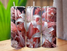 three pink and white vases sitting on top of a wooden table