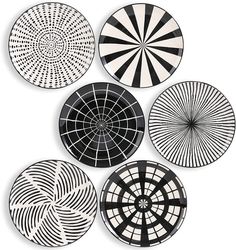 four black and white plates with circular designs on them