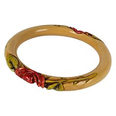 French Art deco carved bakelite rose bangle bracelet. The tubular cream color bracelet is hand carved with a sienna brown stain and cold painted with a deep pink unfurling rose and green stained leaves, rose stems, and thorns. Excellent Condition. 1920's France. Width .50", Interior Diameter 2 5/8" Elegant Bakelite Bangle As Gift, Elegant Bakelite Bangle As A Gift, Elegant Bakelite Bracelets For Gift, Elegant Bakelite Bracelets As A Gift, Color Bracelet, Rose Stem, Color Crema, French Art Deco, Colorful Bracelets