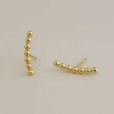 Adorn your ears with 14K solid gold climber stud earrings. Designed for upper earlobe or cartilage, these elegant horizontal beaded line bar studs offer a chic and modern touch to any ensemble. • Sold as a pair for the ear. • 14K Solid Gold (Stamped 14K for Purity Authenticity) • Post Thickness: 22 Gauge (0.6mm) • Item Size: H 13.34mm • Silicone Covered 14K Butterfly Backings • Enjoy Free Shipping & Free Gift Box ** The size may differ depending on measurement methods. ** The color displayed may vary depending on your screen.  . International customer: seller offers international shipping (e.g. USPS International, eBay International Standard Delivery, UPS Worldwide, FedEx international), the buyer is responsible for customs and duty fees unless applicable legislation states otherwise. Retu Stud Piercing, Tragus Conch, Bar Studs, Minimal Jewelry, Bar Earrings, Silicone Cover, Cuff Earrings, Gold Style, Gold Beads