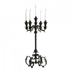 an iron candelabra with five candles on it