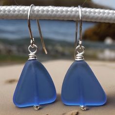 Sky Blue Recycled Glass & Sterling Silver Earrings. The glass used to create these earrings came from glass that would have been left in a landfill, but were rescued and recycled by being crushed into a sand like mixture, remelted and reformed into new glass. The beads are 15mm X 15mm.  Sterling Silver throughout.  Included are rubber stoppers for the ear wires. Not necessary, but sometimes useful. These beautiful sky blue earrings will arrive in a fabric lined gift box with a card and short sto Nickel-free Blue Sea Glass Earrings, Blue Sea Glass Nickel Free Earrings, Blue Sea Glass Nickel-free Earrings, Blue Recycled Glass Dangle Earrings, Blue Recycled Glass Nickel-free Earrings, Nickel-free Blue Recycled Glass Earrings, Handmade Blue Sea Glass Earrings, Blue Nickel-free Recycled Glass Earrings, Nickel Free Blue Recycled Glass Jewelry