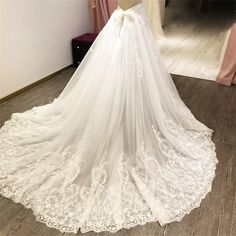 a white wedding dress on display in front of a mirror