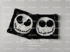 a crocheted square with two faces on it and the words, the honey book written