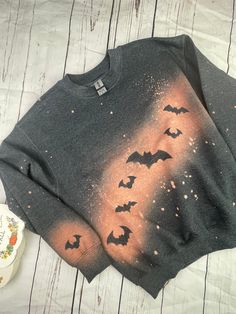 a sweater with bats painted on it