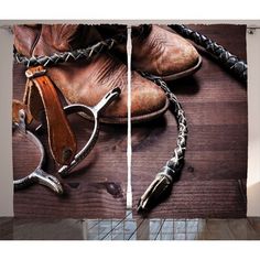 a pair of cowboy boots and two whipsticks on a wooden floor curtain set