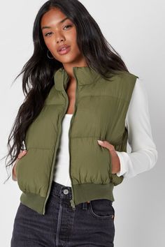 Keep your winter looks toasty and on-trend with the Lulus Warm Aesthetic Olive Green Mock Neck Puffer Vest! Quilted nylon shapes this essential vest that has a mock neckline and a sleeveless bodice with a front zipper. Twin welt pockets offer a cozy spot for your hands, and a cropped, ribbed knit hem completes the look. Fit: This garment fits true to size. Length: Size medium measures 19.75" from shoulder to hem. Bust: Great for any cup size. Waist: Loosely Fitted. Fabric: Fabric has no stretch. Solid Puffer Sleeveless Vest, Spring Nylon Puffer Vest, Trendy Sleeveless Vest For Cold Weather, Fitted Solid Vest For Winter, Trendy Winter Vest For Cold Weather, Casual Fitted Winter Vest, Cold Weather Solid Puffer Vest, Solid Puffer Vest For Cold Weather, Solid Color Puffer Vest For Cold Weather