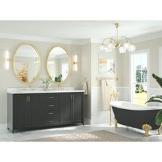 a bath room with a tub a sink and two mirrors on the wall above it