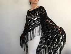 a woman wearing a black crocheted shawl