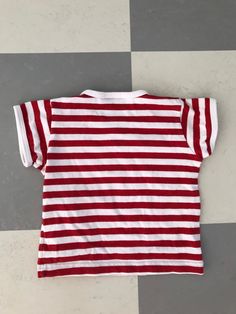 Cute T-shirt from Finnish company Marimekko. This one is if you want to match yourself and your child. 100% cotton. Marked with size 60 cl and fits children up to approx 12 months. Very good condition. Clear colors. Striped in Red and White. ♪♫♬ Don't hesitate to ask for measurements. Cotton Tops With Vertical Stripes And Short Sleeves, Striped Cotton T-shirt With Three Stripes, Striped Cotton T-shirt, Striped Cotton Crew Neck Shirt, Unisex Red Cotton T-shirt, Summer Cotton Tops With Three Stripes, Cotton Summer Tops With Three Stripes, Cotton Short Sleeve Tops With Contrast Stripes, Cotton Tops With Three Stripes And Short Sleeves