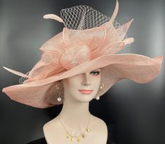 "The oversized brim adorned with a jumbo sinamay bow in and feathers  design characterizes this horse racing event hat made of natural straw. The large brim creates a statement piece, and the sinamay jumbo bow  and netting adds a touch of whimsy and feminine elegance. Crafted from straw, it exudes a light and airy feel, making it a stylish and comfortable choice for a day at the races. The hat combines the classic appeal of a wide brim with the playful charm of a jumbo sinamay bow and netting , Elegant Fedora With Feather Trim, Elegant Hat With Feather Trim And Short Brim, Elegant Wide Brim Hat With Feather Trim, Elegant Short Brim Hat With Feather Trim, Elegant Hats With Feather Trim And Flat Brim, Elegant Hat With Feather Trim And Flat Brim, Chic Feathered Hat For Races, Elegant Mini Hat With Feather Trim And Curved Brim, Elegant Costume Hat With Feather Trim And Curved Brim