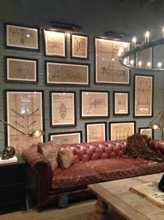 a living room filled with furniture and framed pictures