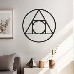 a living room with a couch, chair and wall hanging in the shape of a triangle