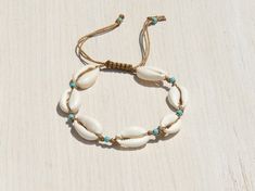 Shell anklet,Shell bracelet , This anklet /bracelet is made of naturel seashell and naturel turquoise beads with adjustable ripcord. İt is simple but elegant. Wear yours alone or with a combination of other bracelets/anklets . İt is great gift for a woman or a girl. When buying this item ,please indicate that you want a bracelet or an anklet. Bracelet size 6.5''(16.5-17cm)This bracelet is adjustable size with a sliding knot and will fit most wrists. Anklet size 8'' (20-21cm) This anklet is adjus Shell-shaped Beaded Bracelets For Beach Season, Adjustable Shell Beaded Bracelets For Beach Season, Bohemian Beaded Bracelets With Adjustable Shell, Bohemian Adjustable Anklets For Beach, Adjustable Bohemian Shell Friendship Bracelets, Bohemian Shell Friendship Bracelets, Turquoise Bohemian Strand Friendship Bracelets, Bohemian Beaded Shell Friendship Bracelets, Bohemian Adjustable Shell Beaded Bracelets