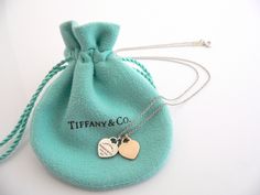 Show off your Tiffany style without ever saying a word! Here's a Tiffany & Co. Sterling Silver & 18K Rose Gold "Return to Tiffany" Mini Double Hearts necklace that is just perfect! It is the wonderful necklace that fits a lifestyle on the go -- the necklace can be worn to pretty much any occasion! It is simple, elegant, and classic all rolled into one necklace. Imagine wearing the necklace with your office attire... now imagine it with jeans or weekend wear ... Perfect anytime! The item Return To Tiffany Necklace, Rose Gold Heart Necklace, Tiffany And Co Bracelet, Tiffany And Co Jewelry, Preppy Jewelry, Return To Tiffany, Tiffany Necklace, Double Heart Necklace, Pearl Heart