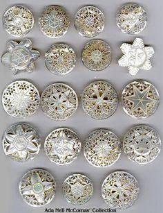 an assortment of silver colored buttons and brooches