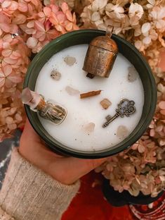 a person holding a cup filled with milk and keys