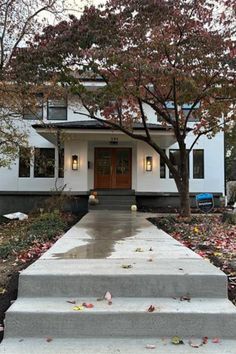 a white house with steps leading up to the front door