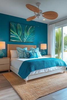 a bedroom with blue walls and white bedding in front of a large glass window