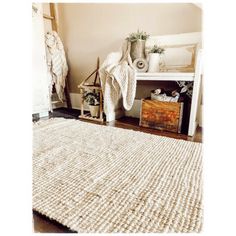 a white rug sitting on top of a wooden floor