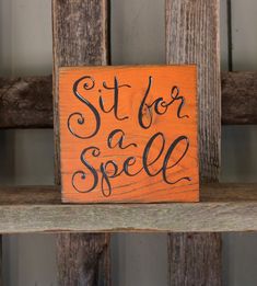 a wooden sign that says sit for a spell