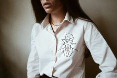 White Long Sleeve Shirt With Machine Embroidery, White Floral Embroidered Shirt For Work, White Fitted Top With Machine Embroidery, Fitted White Tops With Machine Embroidery, Fitted White Top With Machine Embroidery, White Long Sleeve Shirt With Embroidered Graphics, Embroidered White Shirt For Work, Embroidered White Shirt For Workwear, White Embroidered Shirt For Workwear