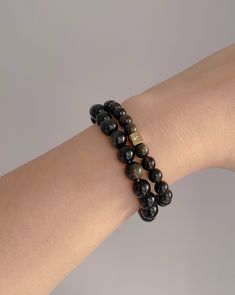 Each smooth, lustrous bead shimmers with an enchanting golden sheen, creating a captivating play of light. The deep, rich black color of the obsidian provides a striking contrast, making this bracelet a truly mesmerizing accessory. Whether worn alone for a touch of understated sophistication or layered with other pieces for a more dramatic statement, this bracelet is the perfect addition to any jewelry collection, allow its spiritual essence to accompany you on your quest for inner harmony and e Elegant 8mm Beads Bracelet For Meditation, Round Obsidian Meditation Bracelets, Spiritual Round Obsidian Bracelets, Spiritual Obsidian Round Bracelets, Hand-strung Obsidian Bracelet, Spiritual Obsidian Bracelets, Adjustable Obsidian Polished Bead Jewelry, Adjustable Obsidian Jewelry With Polished Beads, Obsidian Beaded Bracelets With 8mm Beads As Gift