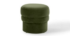 a green round ottoman sitting on top of a white floor