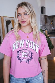 Show your love for the New York Athletic Department with this quirky pink graphic tee. Featuring a crew neckline and a cropped fit, this tee is perfect for a casual yet stylish look. Express your unique style with this eye-catching tee. General Info: 100% Cotton Hand Wash Cold; Dry Flat Crew Neckline Graphic Tee Cropped Fit Guide: Shape & Fit: Relaxed Fabric Elasticity: No Stretch Fabric Texture: Soft Model Info: Height: 5’6” | Bust: 34” | Waist: 25” | Hip: 34” | Size Shown: Small Pink Graphic Tee, Fabric Texture, Clothing Company, Crew Neckline, Stretch Fabric, Graphic Tee, Unique Style, Graphic Tees, Hand Wash