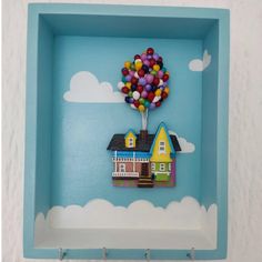 there is a blue box with a house and balloons in it