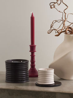 two vases and a candle on a table