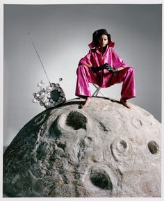 a man sitting on top of a large rock next to a knife and some bubbles