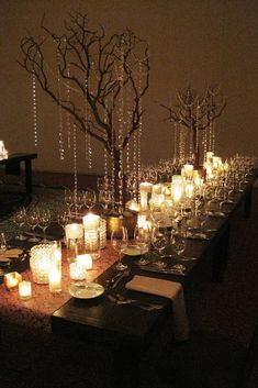 a long table is set with candles and place settings for dinner guests to sit at