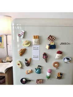 a refrigerator with magnets on it in a kitchen