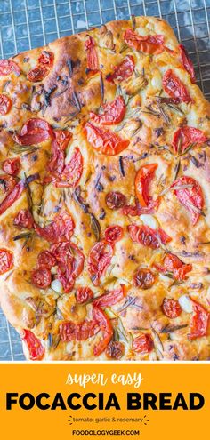 a pizza with tomatoes and cheese on it sitting on top of a cooling rack next to the words super easy focaccia bread