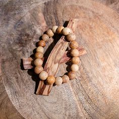 In Spanish, Palo Santo translates to "Holy Wood" and it grows in the coastal regions of South America. These bracelets are made of 100% palo santo wood and are very fragrant when worn. Natural Wooden Beads Spiritual Bracelet, Holistic Wooden Beads Bracelets For Meditation, Spiritual Natural Wood Beaded Bracelets, Holistic Wooden Beads Healing Bracelet, Natural Wood Beaded Bracelets As Gift, Natural Wood Beaded Bracelet As Gift, Natural Wood Beaded Bracelets For Gifts, Rustic Wooden Beads Bracelet, Nature-inspired Natural Color Bracelet As A Gift