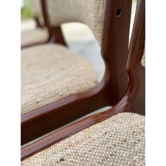 a close up view of the back of a chair with wood trimmings and fabric