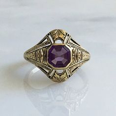 Details: Victorian 14K gold Art Deco amethyst ring circa 1930's. Beautiful deco design, with leaf inspired pattern. The lovely amethyst measures 6.7mm x 6.7mm, and sits about 5.5mm from the finger. The setting measures 15.4mm from top to bottom. The ring is in excellent condition. Please ask all necessary questions prior to placing an order. Measurements: The size is 7 US and can be sized for a fee. Condition: The overall all condition of this ring is excellent condition and the stone is securel Luxury Art Deco Purple Amethyst Ring, Antique 14k Gold Amethyst Ring, Purple Amethyst Hallmarked Signet Ring, Classic Purple Amethyst Ring, Art Deco Gemstone Signet Ring For Formal Occasions, Formal Art Deco Gemstone Signet Ring, Classic Purple Gemstone Signet Ring, Formal Purple Gemstone Signet Ring, Elegant Purple Amethyst Ring With Intricate Design