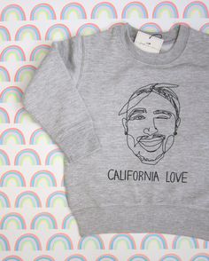 Tupac California Love sweatshirt. Great sweater for cooler summer nights and chilly fall mornings. For the little mini's in your life repping the West Coast with California Love. Heather grey with illustration by Joseph+Sue. Unisex --perfect for boys or girls. Super Soft fleece --to bundle up with Coverstitch shoulders and armholes --for a good fit Coverstitch ribbed collar, cuffs and waistband --to keep the chill out 60/40 Cotton/polyester fleece blend --cozy Fabric weight 7.5 oz Tupac Changes, Tupac California Love, Chilly Fall Morning, Tupac Shirt, 90's Hip Hop, All Eyez On Me, Hip Hop Clothing, 90s Hip Hop, Cozy Fabric