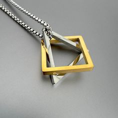 Interlocking triangle and square pendant on silver stainless steel chain. Use triangle and square interlocking pendants together or individually.  Chain length 24 inches High-grade stainless steel. CARE: Stainless Steel:  Use a polishing cloth to gently wipe this item clean, then remove any remaining tarnish with mildly diluted soap. Rinse with warm water and dry thoroughly.  STORAGE: When not in use, store your item in the provided jewelry pouch. We gladly accept returns and exchanges if the it Modern Stainless Steel Square Pendant Necklace, Ancient Egyptian Jewelry, Square Pendant Necklace, Triangle Square, Egyptian Jewelry, Square Pendant, La Jolla, Steel Chain, Jewelry Pouch