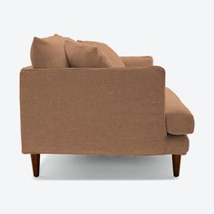 a brown couch sitting on top of a white floor