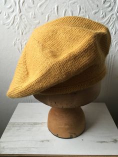 "This mustard knit beret is made from gorgeously soft alpaca, meaning it is soft and cosy but still light and comfortable. I've knitted a classic Scottish tam style, with softly rolled brim so that it's easy to put on and can be folded up and kept in your pocket for chilly days.  Equally great for men or women, this hat is sized to fit the average head, coming up at 22.5\" (57cm) circumference / 11\" diameter. If you need slightly bigger or smaller please let me know and I'll be happy to knit you a perfect fit. Matching gloves are available in my shop too, if you want the full cosy set! They also make a really lovely gift. All my pieces are made by my in my little north Devon studio." Yellow Beret, Dapper Gentleman Style, Knit Beret, Knitted Beret, Yellow Hat, Capsule Outfits, Sparkly Dress, Hat Knitting Patterns, Berets