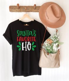 Santa's Favorite Ho Shirt, Funny Christmas Tee, Adults Funny Christmas Shirt, Xmas Party T-Shirt Gift for Her, Christmas Party Santa T-Shirt 🎅 👚Santa's Favorite Ho Shirt 👚 🎅 ❄️Bring the laughs this holiday season with our hilarious Funny Christmas Tee! Perfect for anyone who loves a good giggle, this t-shirt is sure to be a hit at any Christmas party. 🌟 🎄 Holiday Ready: Dress up for your next Xmas party with a tee that's as funny as it is festive! Featuring a playful Santa graphic, it's th Christmas Tshirt Designs Funny, Funny Christmas Tees, Christmas Graphic Tee Shirt For Holiday, Dirty Christmas Shirts, Funny Christmas Shirts For Women, Santa Graphic, Santas Favorite Ho, Christmas T Shirt Design, Teacher Outfit