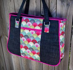 a handbag hanging on the side of a wooden fence