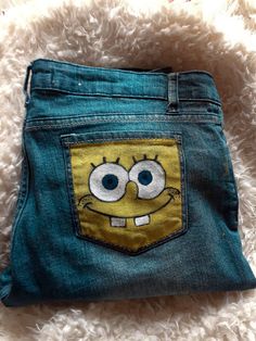 a pair of blue jeans with an image of spongebob in the pocket